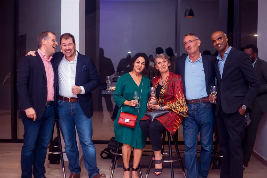 Guests posing together with drinks at an evening reception